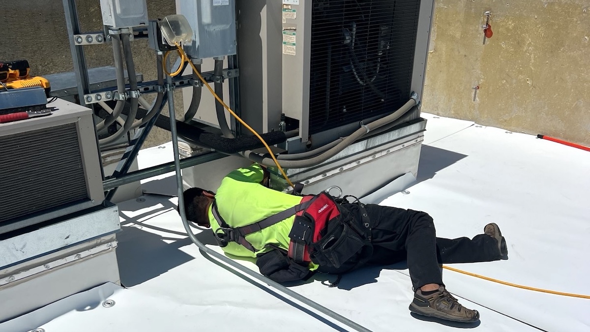 Commercial Roofer Meticulously Installing TPO Membrane Around CJH's Rooftop HVAC Units